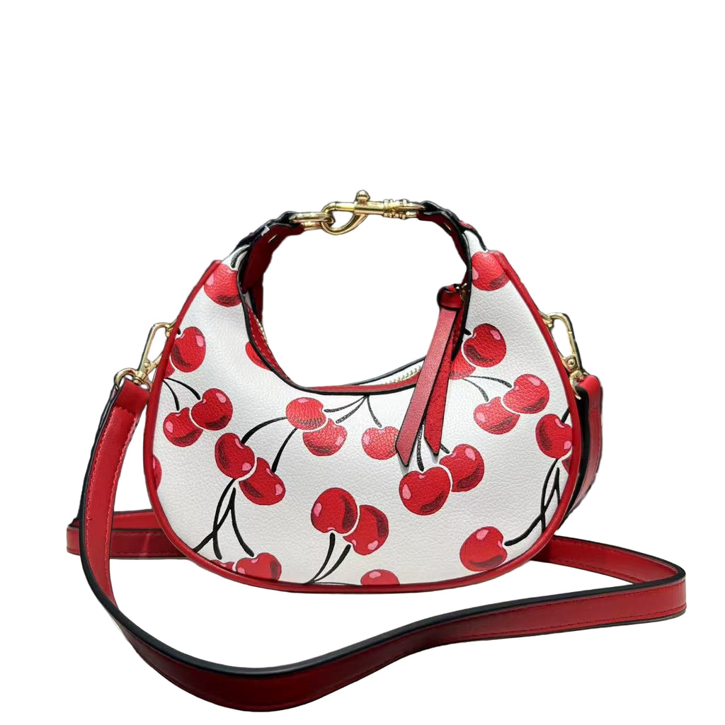 Handbag with cherry design on a white surface with black background