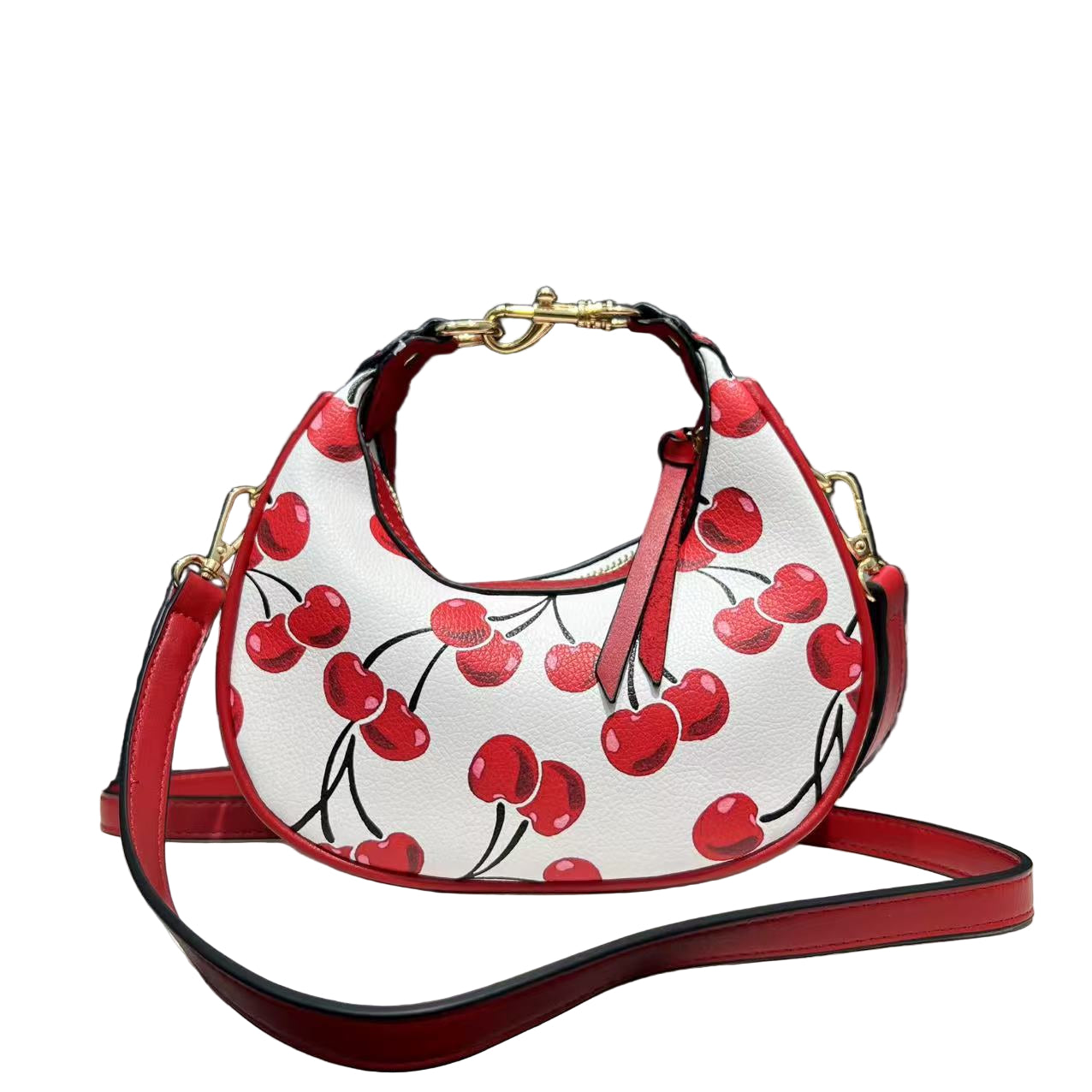 Handbag with cherry design on a white surface with black background