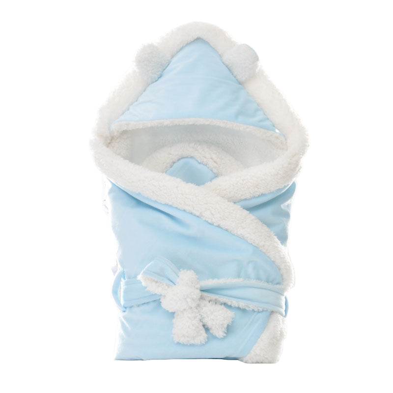 Newborn baby being hugged and swaddled by baby